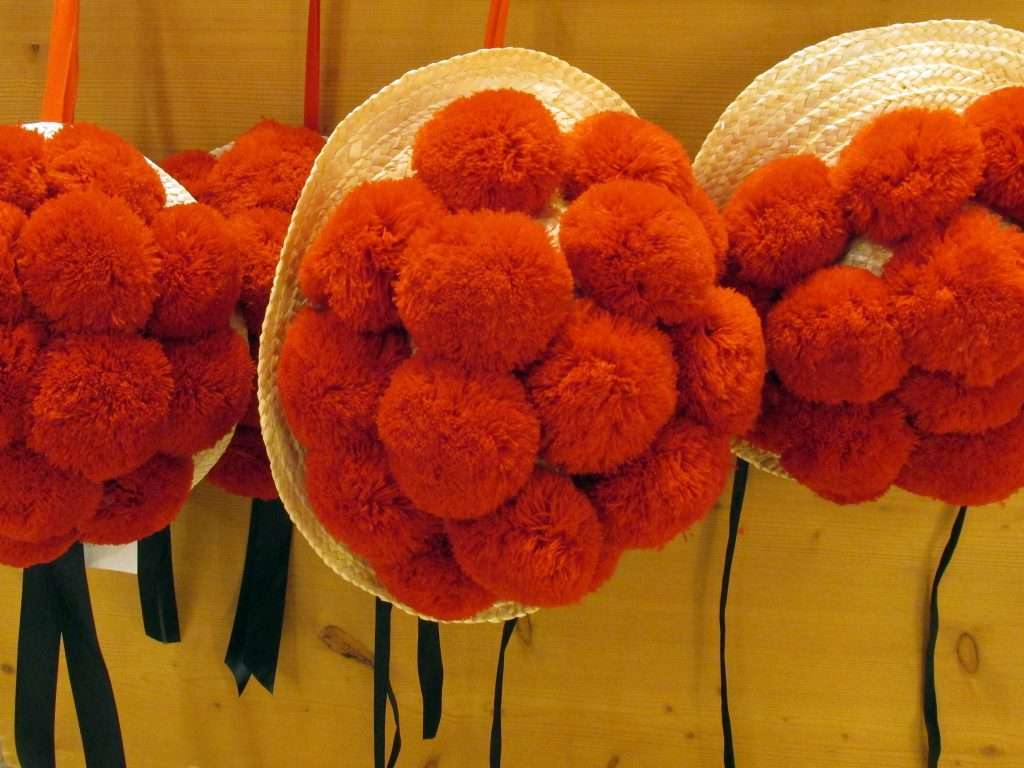 Beanie hats with red wool balls